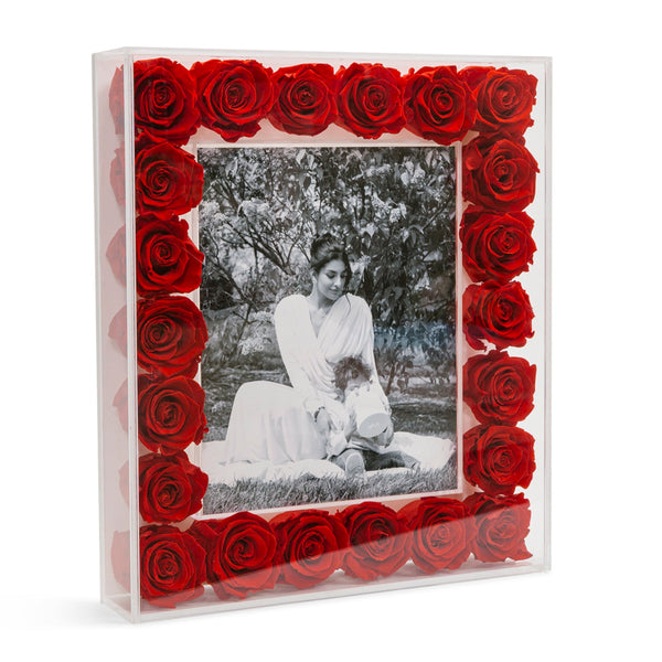 Photo frame with red roses encased in clear acrylic, containing a black-and-white photo of a woman and child sitting outdoors.